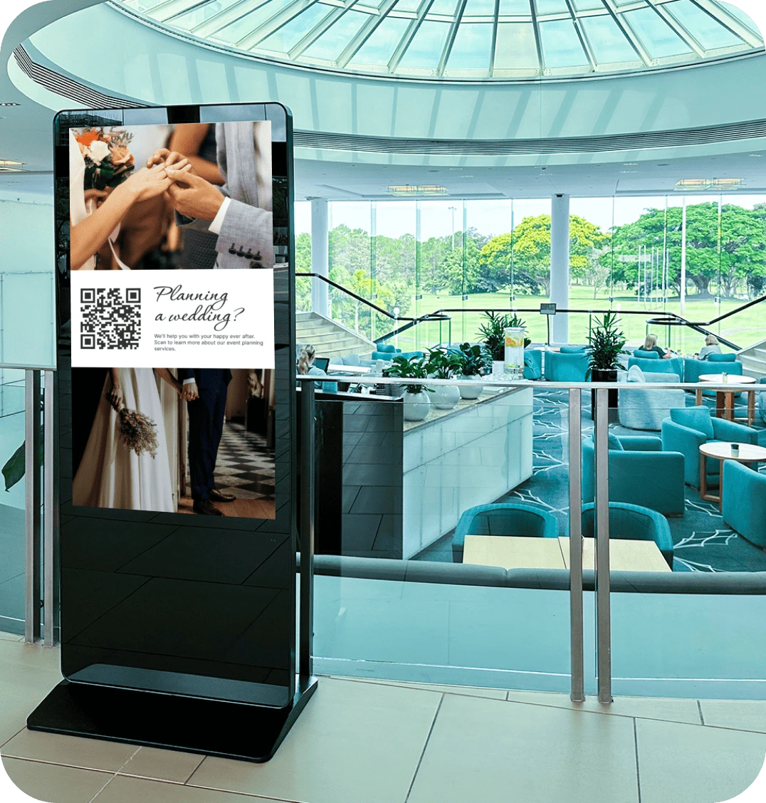 A digital signage screen in a hotel displays a promotion for their wedding planning services