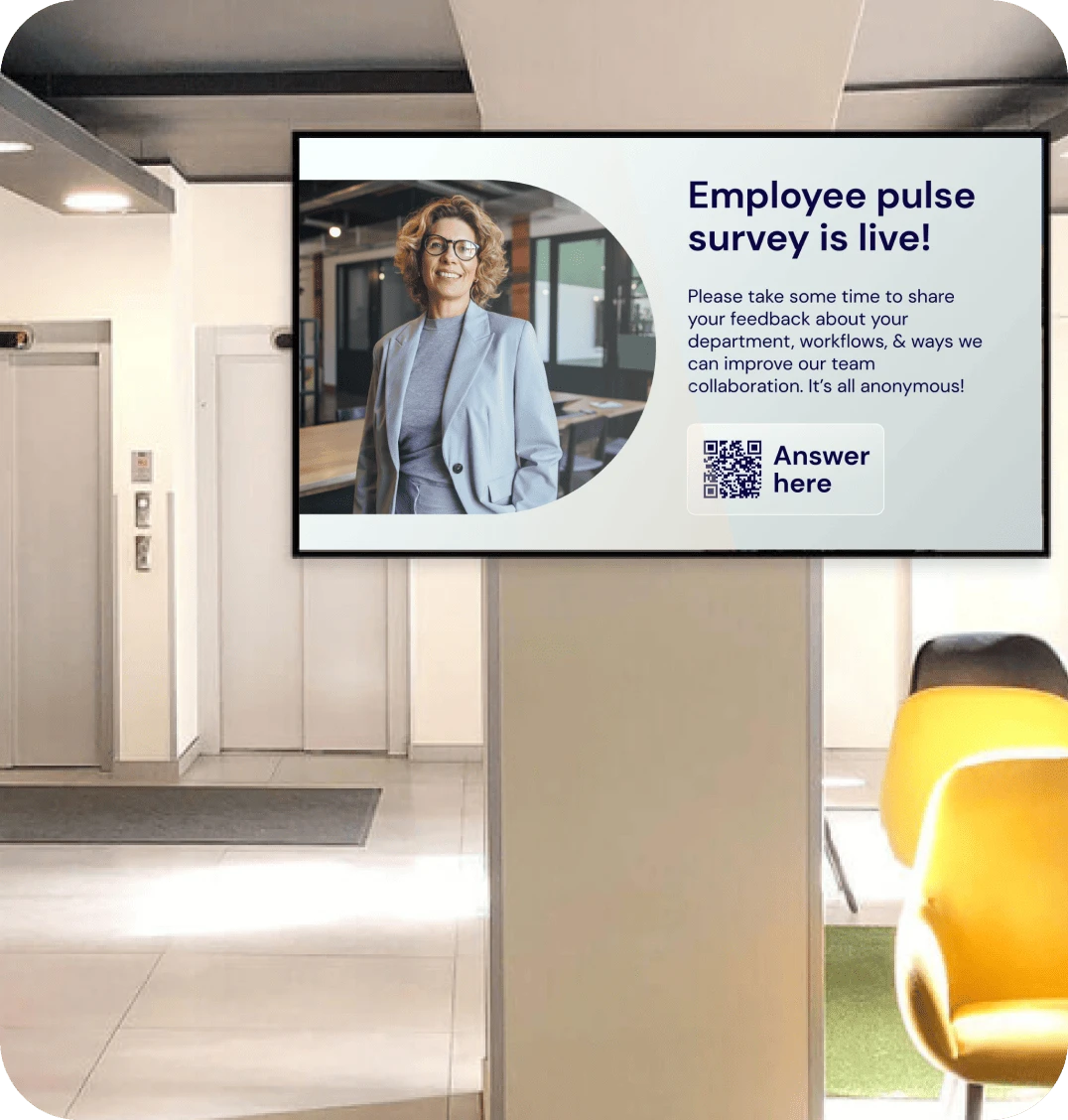 A digital signage screen in a retail store back office shows a slide with a QR code to an employee survey