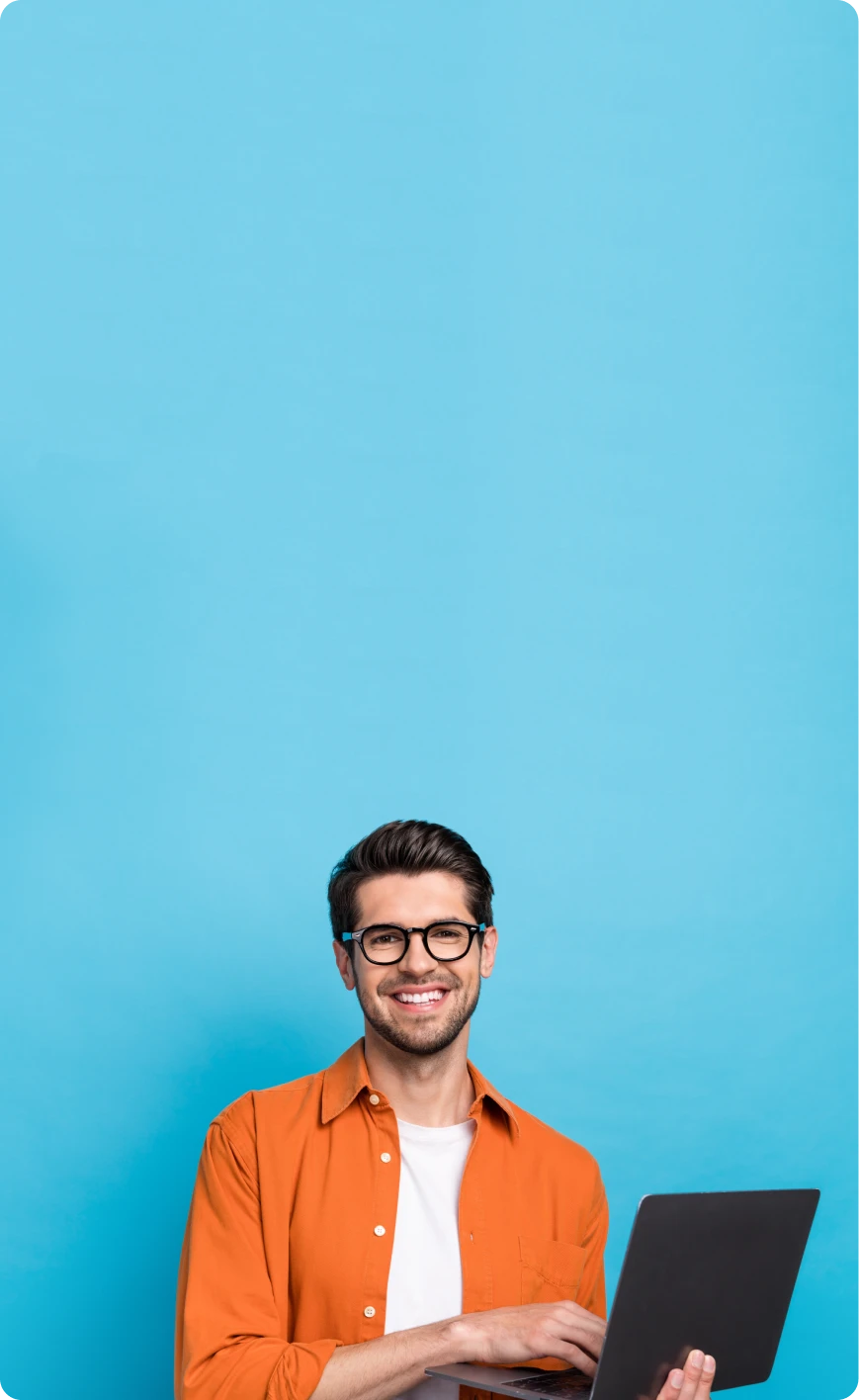 A male employee is standing with his laptop in front of