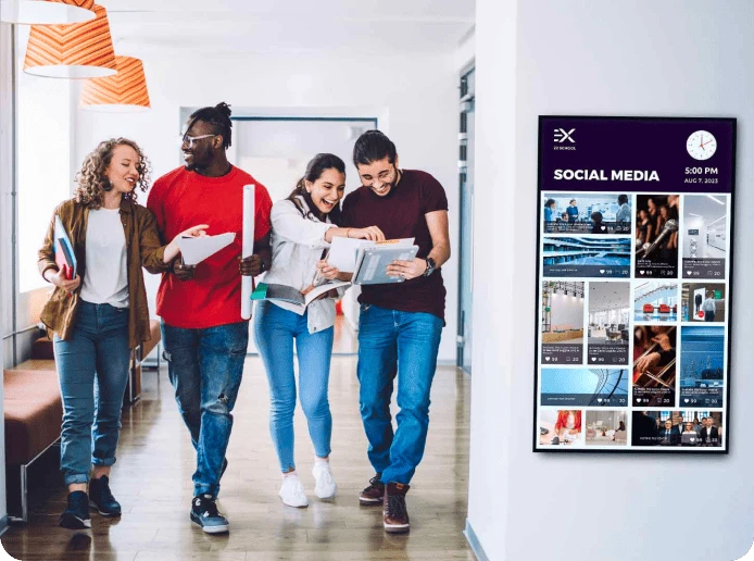 A university digital signage screen displays a social media wall with photos from their instagram account