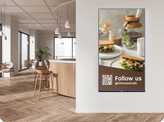 A digital signage display shows an image of brunch with a QR code and link to the cafe's Instagram